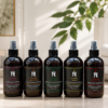 AromaHoliday World Spa luxury room and linen spray collection featuring Energise, Bloom, Restore, Sensual and Glow fragrances in recyclable amber bottles.