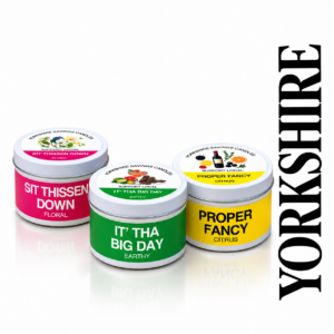 AromaHoliday Yorkshire Sayings candles in pink, green and yellow tins