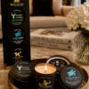 AromaHoliday Spice of Life luxury candle gift set with a lit handmade soy candle displayed on a decorative tray in an elegant modern living room.