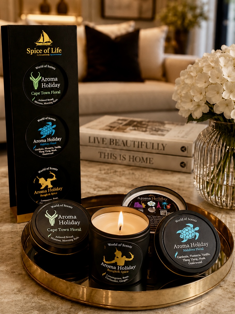 AromaHoliday Spice of Life luxury candle gift set with a lit handmade soy candle displayed on a decorative tray in an elegant modern living room.