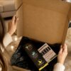 Opening an AromaHoliday luxury candle gift box at home, revealing the Spice of Life travel-inspired candle gift set wrapped in premium tissue paper.